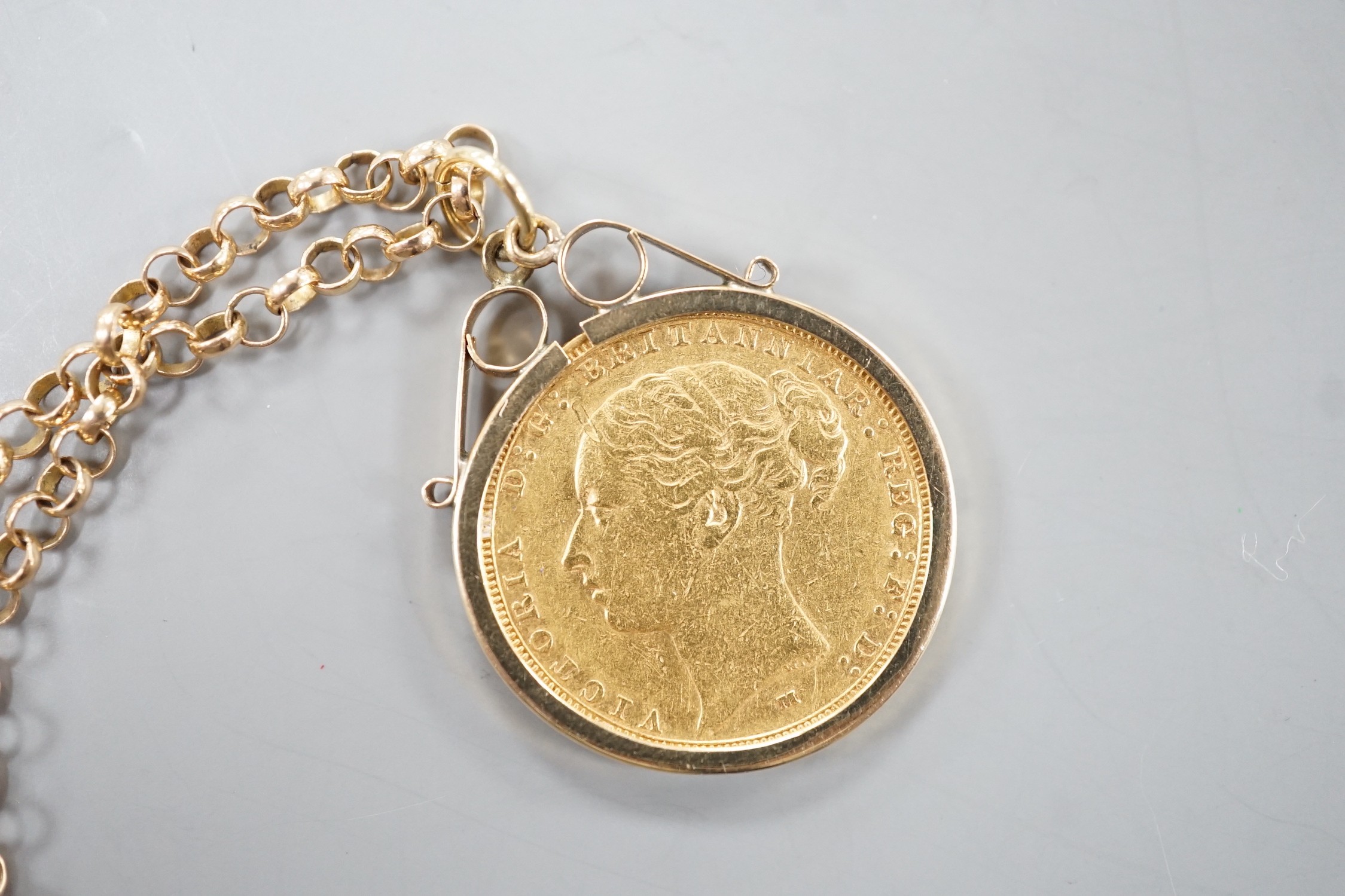 A Victoria 1883 gold sovereign, in a later 9ct gold pendant mount, on a 9k chain